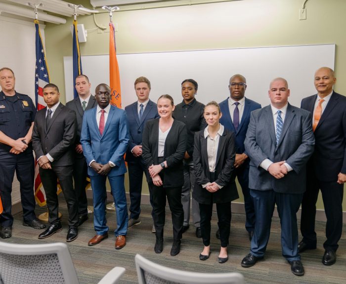 Pictured from left to right in the front row are First Deputy Chief Richard Shoff of the Syracuse Police Department, Donovan Green, Teng Kiir, Delana Thomas, Kit Diana and Thomas Bingham. Pictured from left to right in the back row are Sean McCaffery, Liam Welling, Keyatta Green, Barrington Wallace and Chief Craig Stone.