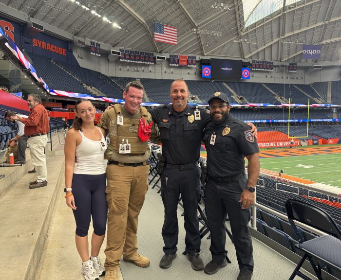 Leah Sullivan, Joe Hernon, Commander Jeremy Welling and Liuetenant Alvarez stand in the JMA WIreless Dome after 9/11 Stair Climb